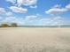 Beautiful sandy beach featuring a volleyball net, ideal for outdoor activities and enjoying the waterfront at 4321 Rummell Rd, St Cloud, FL 34769