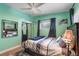Bedroom with a large mirror reflecting natural light and a ceiling fan to enhance airflow at 4321 Rummell Rd, St Cloud, FL 34769