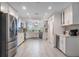 Well-lit kitchen with white cabinets, stainless steel appliances, and lots of counter space at 4321 Rummell Rd, St Cloud, FL 34769