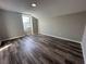 Bright bedroom with wood-look floors and a large window at 523 Royal Ridge Dr, Davenport, FL 33837