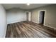 Spacious bedroom with wood-look flooring and access to other rooms at 523 Royal Ridge Dr, Davenport, FL 33837