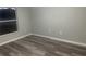 Simple bedroom with wood-like flooring and large window at 523 Royal Ridge Dr, Davenport, FL 33837