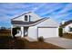 Front view of a light gray house with a white garage door and a neatly trimmed lawn at 523 Royal Ridge Dr, Davenport, FL 33837