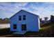 Two-story house with light blue exterior and backyard at 523 Royal Ridge Dr, Davenport, FL 33837