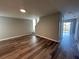 Spacious living room with wood-look flooring and access to other rooms at 523 Royal Ridge Dr, Davenport, FL 33837