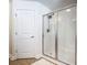 Bathroom shower with glass doors, chrome fixtures and tiled floor with a white bath mat at 703 Elkhorn Fern Ln, Deland, FL 32720