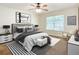 Beautiful bedroom with a large bed, neutral tones, modern decor and a plush rug at 703 Elkhorn Fern Ln, Deland, FL 32720