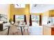 Bright dining room boasting high ceilings, large windows with backyard views, and stylish decor at 8544 Palm Harbor Dr, Kissimmee, FL 34747