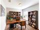 Dedicated home office with wooden desk, bookshelves, and ample storage space at 8544 Palm Harbor Dr, Kissimmee, FL 34747
