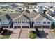 Aerial view of townhomes near a lake, showcasing community and landscape at 1292 Wispy Cypress Dr, Kissimmee, FL 34746