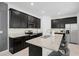 Beautiful kitchen featuring granite countertops, dark cabinets, and stainless steel appliances at 15109 Willow Arbor Cir, Orlando, FL 32824