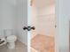 Half-bathroom with open closet featuring wire shelving at 5249 Villa Rosa Ave, St Cloud, FL 34771