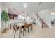 Open-concept dining room with table and chairs leading to kitchen and staircase at 5249 Villa Rosa Ave, St Cloud, FL 34771