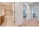 Hallway leading to the bedroom, which has neutral-toned walls, carpet, and wooden doors at 5249 Villa Rosa Ave, St Cloud, FL 34771