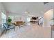 Open-concept living room with stylish seating, area rug, and easy access to the dining area and kitchen at 5249 Villa Rosa Ave, St Cloud, FL 34771