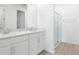 Bright bathroom featuring double vanity, white cabinets, and a glass-enclosed shower at 1753 Carnelian St, Deland, FL 32720