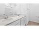 This well-lit bathroom has double sinks, a large mirror, and a shower with tile surround at 1753 Carnelian St, Deland, FL 32720