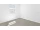 This bedroom is painted in a bright white, has an electrical outlet, a window, and carpet flooring at 1753 Carnelian St, Deland, FL 32720
