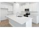 Modern kitchen with white cabinetry, stainless steel appliances, and a spacious island at 1753 Carnelian St, Deland, FL 32720