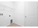This laundry room features wire shelving, wood-look floors, and includes hook-ups for a washer and dryer at 1753 Carnelian St, Deland, FL 32720