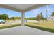 This covered porch offers an outside view of the street, landscaping, and neighborhood beyond at 1753 Carnelian St, Deland, FL 32720