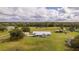 Expansive property featuring a charming home, lush greenery, and outbuildings, offering a serene countryside lifestyle at 4121 Albritton Rd, St Cloud, FL 34772