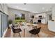 Well-lit dining area showcasing modern table, chairs, and sliding glass doors to backyard at 905 Valencia Rd, South Daytona, FL 32119