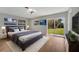 Serene main bedroom featuring a large bed, soft rug, and sliding glass door with backyard view at 905 Valencia Rd, South Daytona, FL 32119