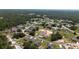 Aerial view of a suburban neighborhood with a mix of homes, trees, and green spaces at 1415 Orlando Way, Kissimmee, FL 34759