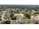 An aerial shot shows the layout of homes nestled amongst the Florida trees at 1415 Orlando Way, Kissimmee, FL 34759