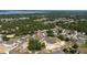 An aerial view shows the neighborhood and surrounding lush green landscape at 1415 Orlando Way, Kissimmee, FL 34759