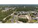 An aerial view shows the neighborhood and surrounding lush green landscape at 1415 Orlando Way, Kissimmee, FL 34759