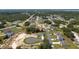 An aerial view shows the neighborhood and surrounding lush green landscape at 1415 Orlando Way, Kissimmee, FL 34759