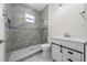 Beautiful bathroom featuring a tiled shower, stylish vanity, and modern fixtures at 1415 Orlando Way, Kissimmee, FL 34759