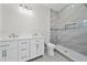 Modern bathroom featuring double sink vanity, updated fixtures, and tiled walk-in shower with blue accents at 1415 Orlando Way, Kissimmee, FL 34759