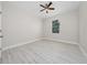 A simple bedroom with a ceiling fan, window and light wood-look flooring at 1415 Orlando Way, Kissimmee, FL 34759