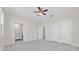 Bright and spacious bedroom featuring a ceiling fan, wood-look floors, and closet doors at 1415 Orlando Way, Kissimmee, FL 34759