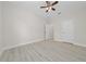 A bright bedroom featuring clean, neutral walls and wood-look flooring at 1415 Orlando Way, Kissimmee, FL 34759