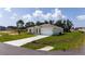Well-maintained single-story home with a two-car garage, landscaped front yard, and a long concrete driveway at 1415 Orlando Way, Kissimmee, FL 34759