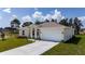 Single Gathering home featuring a well manicured lawn and driveway at 1415 Orlando Way, Kissimmee, FL 34759