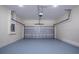 Clean garage with painted floor, white block walls, electrical panel, and overhead door at 1415 Orlando Way, Kissimmee, FL 34759