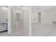 Hallway with wood-look floors leading to a bathroom and kitchen area at 1415 Orlando Way, Kissimmee, FL 34759