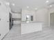 Bright, open kitchen with a large island, stainless steel appliances and a view to the backyard at 1415 Orlando Way, Kissimmee, FL 34759