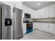 Modern kitchen featuring stainless steel appliances, granite countertops, and white cabinetry at 1415 Orlando Way, Kissimmee, FL 34759