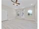 Bright living room features new light wood flooring, recessed lighting, and a ceiling fan at 1415 Orlando Way, Kissimmee, FL 34759