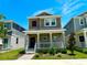 Charming two-story home with a welcoming front porch and well-manicured landscaping at 1608 Cross Prairie Pkwy, Kissimmee, FL 34744