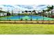 Well-maintained tennis courts within a community, bordered by landscaping and fencing at 1608 Cross Prairie Pkwy, Kissimmee, FL 34744