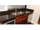 Kitchen features dark countertops, stainless steel sink and dishwasher at 2041 Dixie Belle Dr # 2041P, Orlando, FL 32812