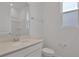 Well-lit bathroom featuring a vanity with countertop, toilet, and a shower with glass doors at 5410 Catmint Dr, Lake Hamilton, FL 33851
