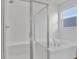 Bright bathroom showcasing a walk-in shower and a soaking tub set beneath a window for natural light at 5410 Catmint Dr, Lake Hamilton, FL 33851